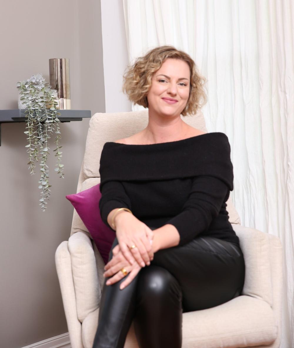 Sarah Buckle, qualified psychotherapist, seated in an armchair